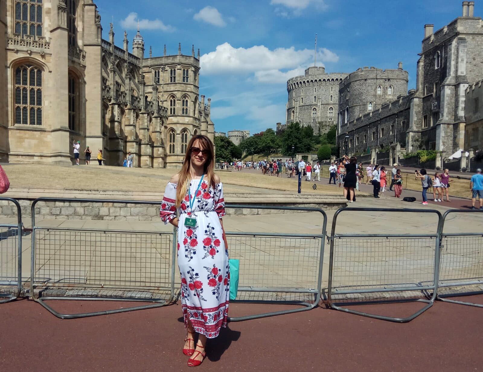 Erika with her guide accreditation in the Lower Ward of Windsor Castle, with St George's Chapel and the Round Tower behind